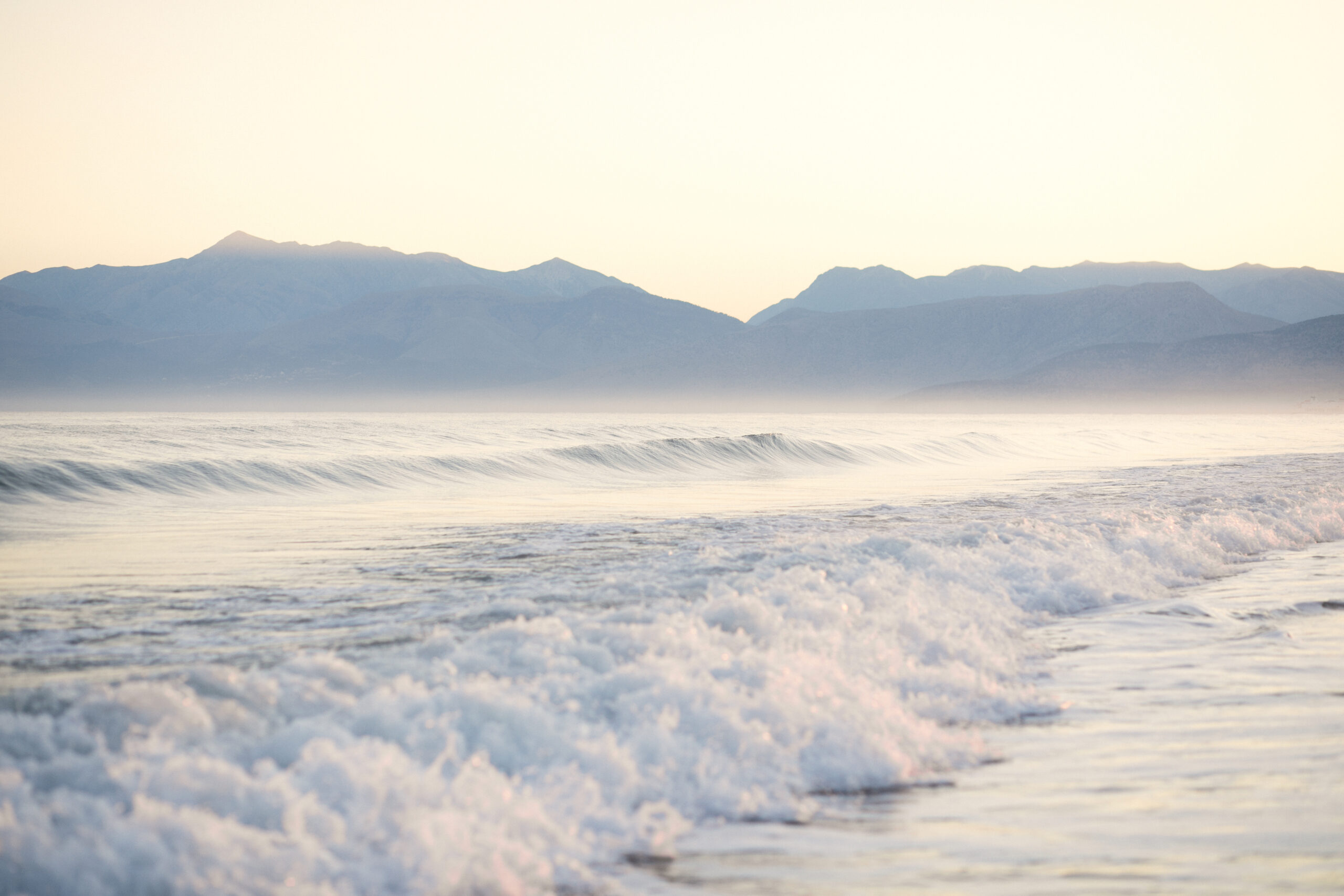 Morning sea in haze with mountain view, soft focus