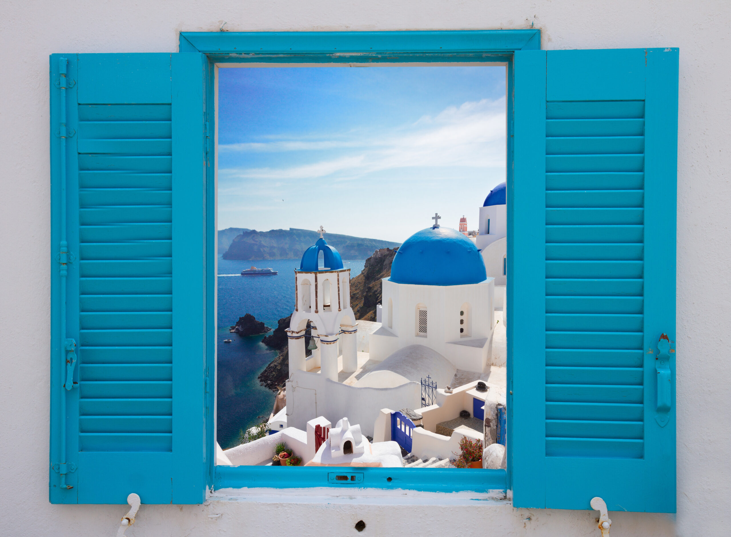 Window with blue shutters with view of town and classical church with blue domes.